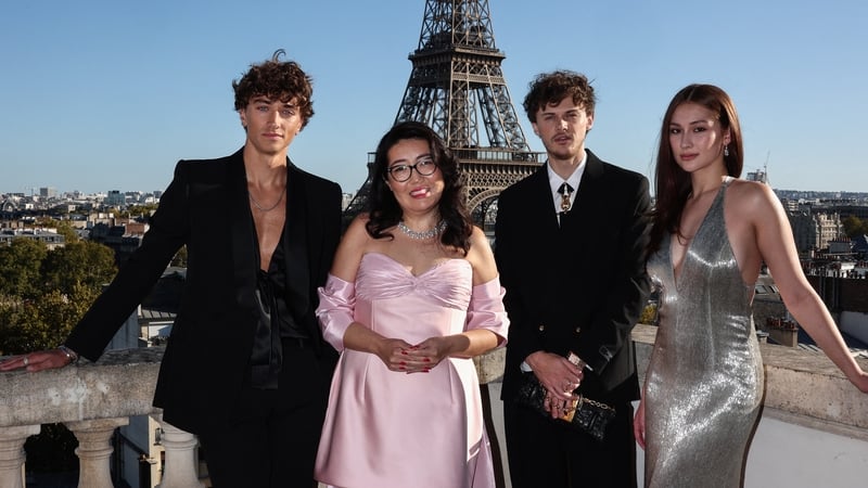 (L-R) Gavin Casalegno, Jenny Han, Christopher Briney, and Lola Tung pose during a photocall on the roof of the Shangri-La Hotel in Paris prior to a special screening of the final episode of The Summer I Turned Pretty on 17 September