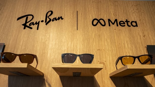Three pairs of small glasses against a wooden background with the Rayban and Meta logos
