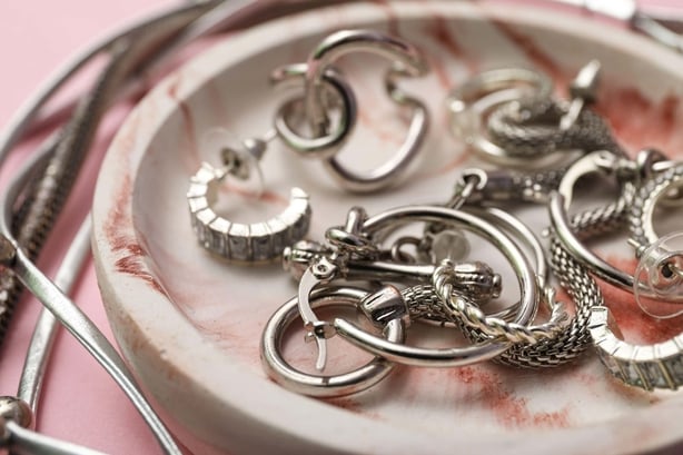 A dish of silver rings