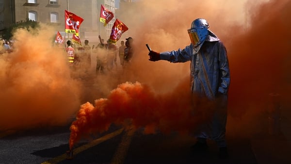 A protester lights flares during a protest in the French city of Marseille