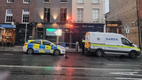 Garda vehicles are seen outside the scene of a fire at a bar on dawson street
