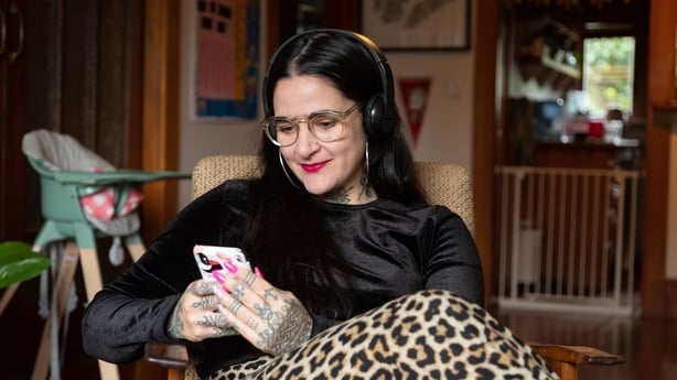 Tattooed mother using phone