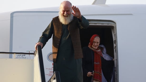 Peter Reynolds waves as he is followed out of the plane by Barbie Reynolds after landing at the airport in Doha 