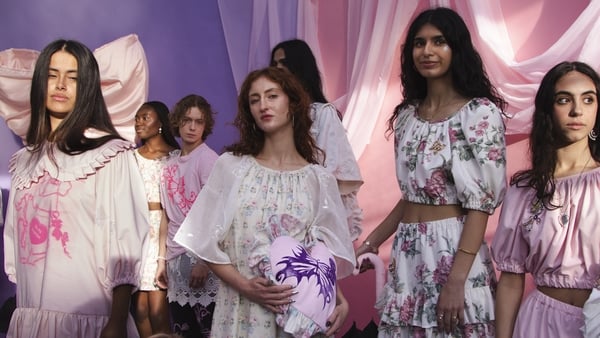 A group shot of models wearing feminine dresses