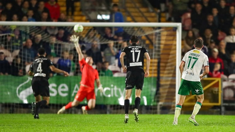 Darragh Crowley (right) looks on as his shot from distance sails over Ed McGinty