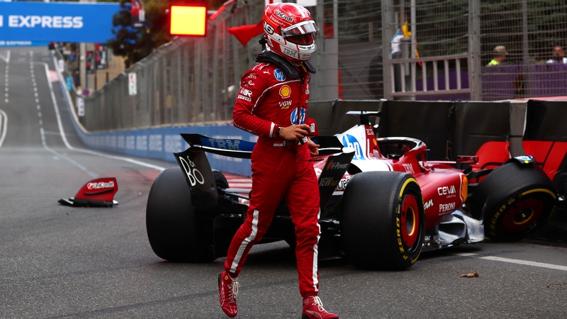 Scuderia Ferrari's Charles Leclerc of walks away from his damaged car after crashing