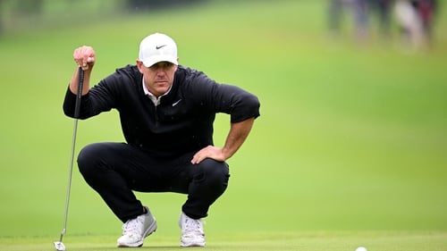 Brooks Koepka lining up a putt on the fifth