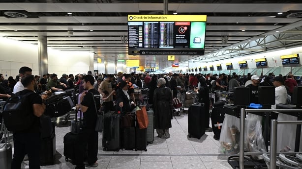 Travellers wait in terminal 4 at Heathrow Airport