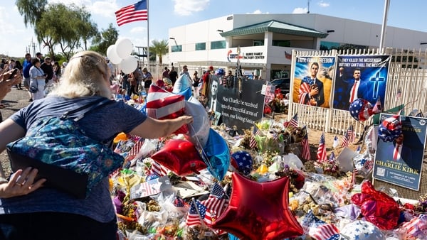 People gather outside Turning Point USA's Phoenix headquarters to commemorate the conservative activist Charlie Kirk