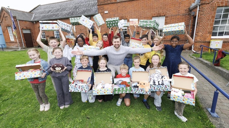 Students from St Peter's National School in Drogheda, Co Louth with Adas Rakauskas who received a Christmas shoebox as a child