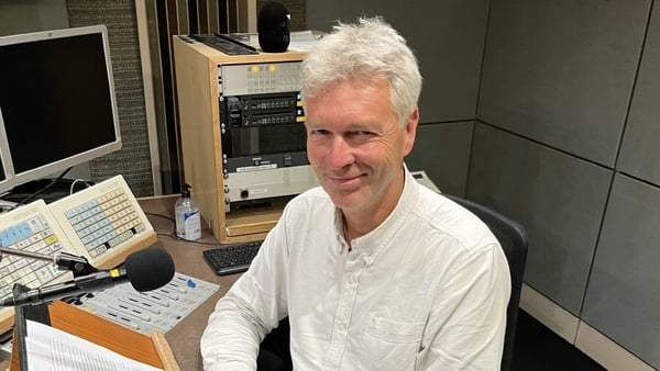 Georg Grote, in RTÉ Radio studio for Sunday Miscellany, behind mic and smiling up at camera, 2025