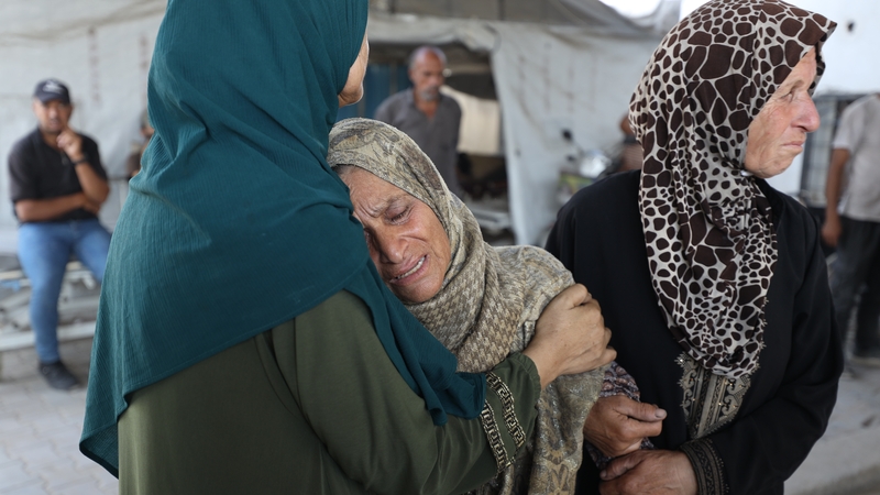 Palestinian women are seen mourning relatives outside Al-Shifa hospital in Gaza City