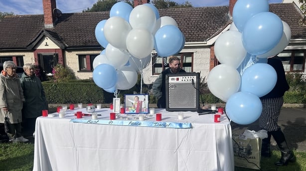Blue and white balloons at a vigil for Daniel Aruebose