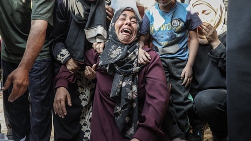 A woman mourns as bodies of people killed in Israeli attacks are brought to Al Shifa hospital
