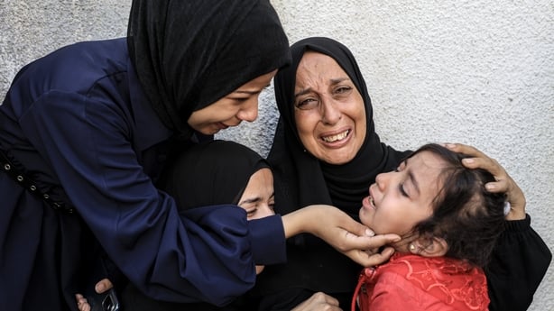 Relatives of slain Palestinians mourn at Al Shifa Hospital