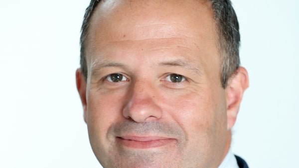 Headshot of a man in a suit
