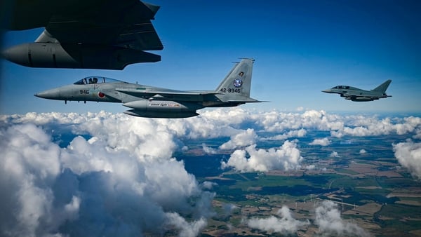 A Japanese Air Self-Defense Force F-15 fighter jet (front) and a German Eurofighter are seen in flight during a joint demonstration as part of a press day at the military air base in Laage, south of Rostock, northeastern Germany on September 23, 2025. (Ph