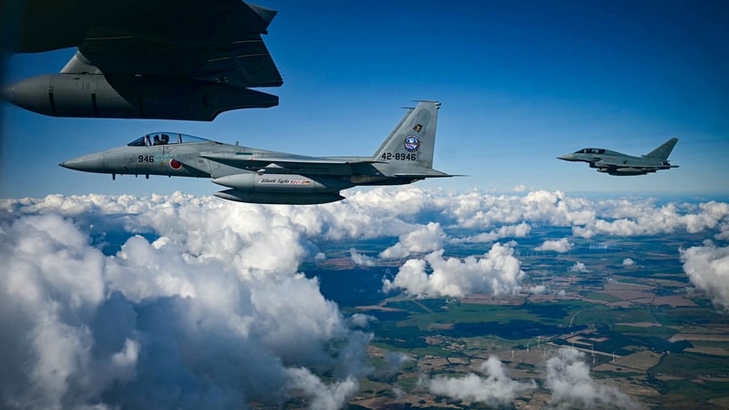 A Japanese Air Self-Defense Force F-15 fighter jet (front) and a German Eurofighter in flight during a joint demonstration at the military air base in Laage, south of Rostock, northeastern Germany