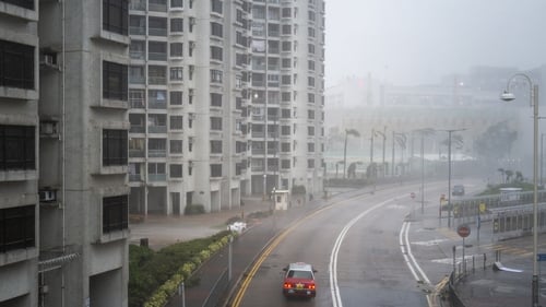 A taxi passes through the Heng Fa Chuen residential area during Super Typhoon Ragasa in Hong Kong, China