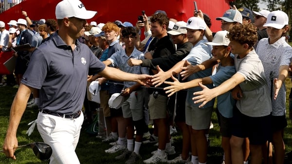FARMINGDALE, NEW YORK - SEPTEMBER 23: Justin Thomas of Team United States high-fives fans as he walks to the 12th hole tee box prior to the Ryder Cup 2025 at Black Course at Bethpage State Park Golf Course on September 23, 2025 in Farmingdale, New York. (