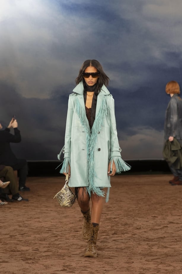 A model wearing a pale blue coat