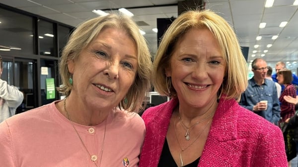 Aine Lawler and Mary Wilson surrounded by colleagues in the background