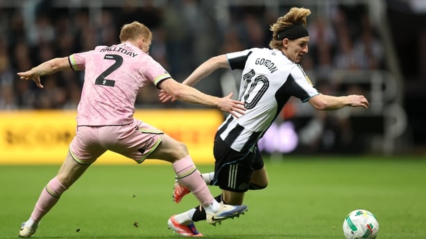 Anthony Gordon of Newcastle United is challenged by Brad Halliday of Bradford City during the Carabao Cup Third Round match between Newcastle United and Bradford City at St James' Park on September 24, 2025 in Newcastle upon Tyne, England.