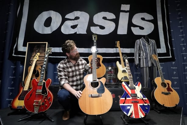 Propstore employee holds Noel Gallagher's Takamine FP460SC acoustic guitar, used to record Wonderwall, with an estimate of�200,000 - �400,000, during a preview for the upcoming music memorabilia auction, taking place in London from October 23-24. Picture date: Tuesday September 16, 2025. PA Photo. M
