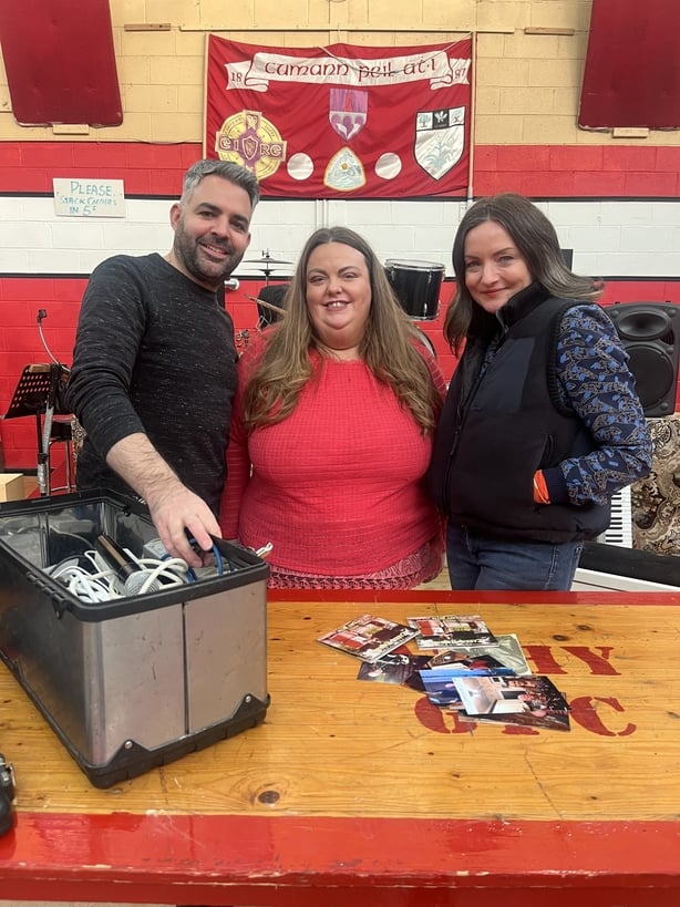 A photo of three people smiling