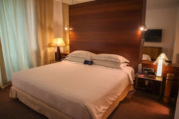 a hotel bedroom with soft lighting