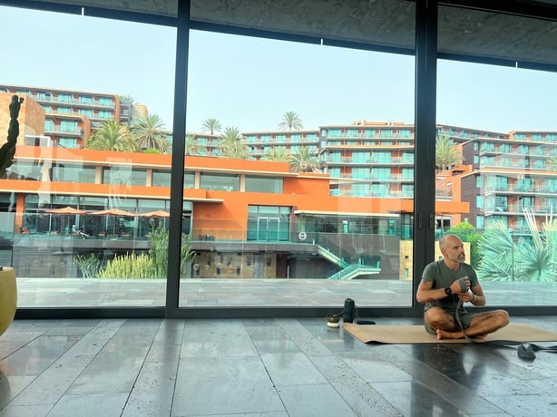 A yoga teacher leading a class in a bright room