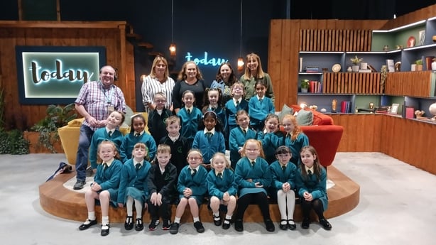 A group of schoolkids in green unifroms on the set of the RTÉ TV show today.
