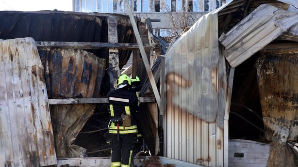 A rescuer works at the site of response efforts following a Russian strike in Kharkiv, Ukraine, on September 24, 2025. During the night of September 24, Russian forces attack the city with 18 kamikaze drones, targeting primarily an energy infrastructure facility. Residential buildings and shops are 