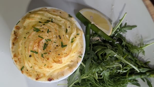Top view of a fish pie, topped with potato