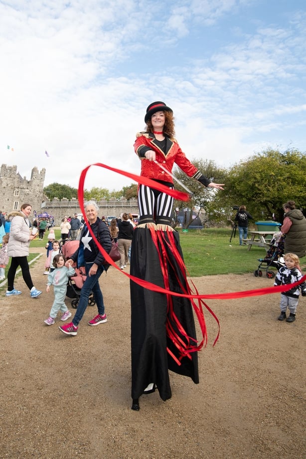 A performer walking on stilts