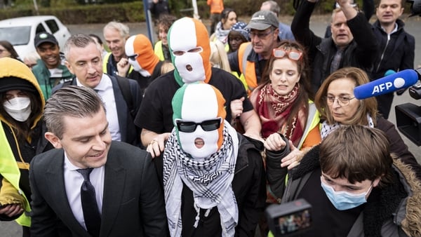 Kneecap's Liam Og O hAnnaidh (centre)with his lawyer Darragh Mackin (left) arriving at Woolwich Crown Court, London, where he is charged with a terrorism offence. 27-year-old Liam Og O hAnnaidh, who performs under the stage name Mo Chara, has been charged