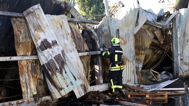 A rescuer works at the site of a Russian strike in Kharkiv, Ukraine