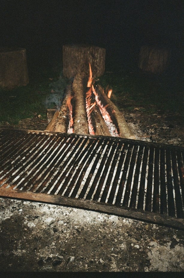 an open grill by a fire