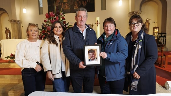 Members of the Donnelly family hold a picture of Colm Donnelly