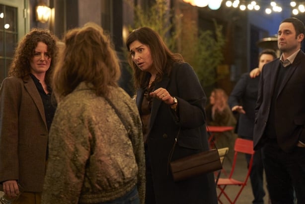 A scene from the Walsh Sisters showing three sisters talking outside
