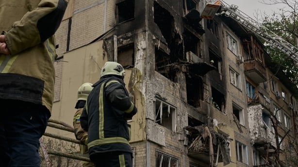 State Emergency Service workers operate at the site of a civilian residential building hit during a Russian overnight attack
