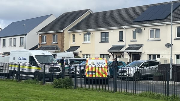 Gardai are pictured outside a house in Finglas where the bodies of a man and young girl were found