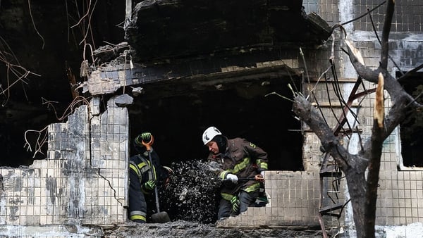 Rescuers work at a residential building hit by a Russian strike in Kyiv, Ukraine