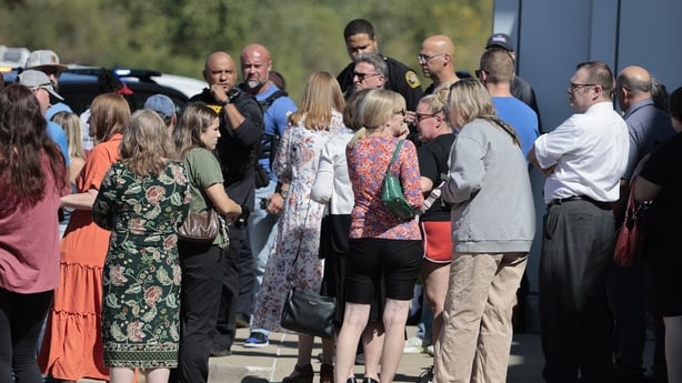 People gather near the scene of a shooting at a church in Grand Blanc, Michigan