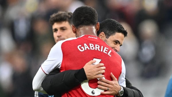 Arsenal's Spanish manager Mikel Arteta (R) embraces Arsenal's Brazilian defender #06 Gabriel Magalhaes (L) on the pitch after the English Premier League football match between Newcastle United and Arsenal at St James' Park in Newcastle-upon-Tyne, north ea