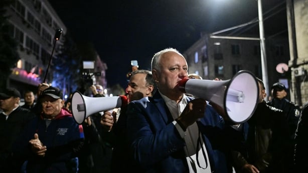 Igor Dodon speaks to crowds using a megaphone outside the Electoral Commission in Chisinau
