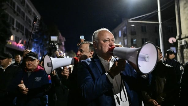 Igor Dodon, the leader of Socialist Party, uses a megaphone to address a small gathering of protesters in front of the Central Electoral Commission (CEC) alleging electoral fraud as votes continue to be counted, in Chisinau, Moldova on September 28, 2025. Moldovans were voting on September 28 in par