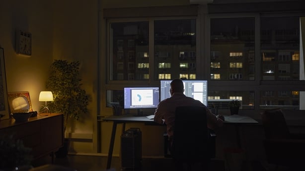 Silhouette male professional working late night at home office.