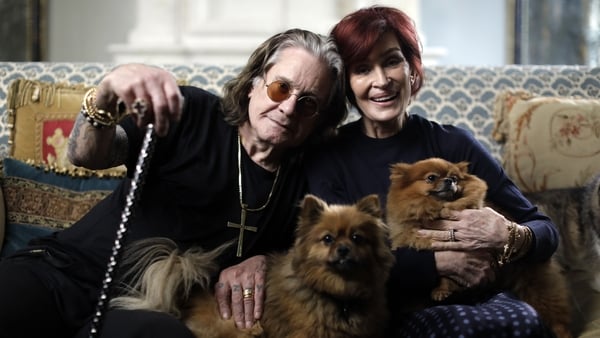 Ozzy Osbourne and Sharon Osbourne pose for a photo with their dogs