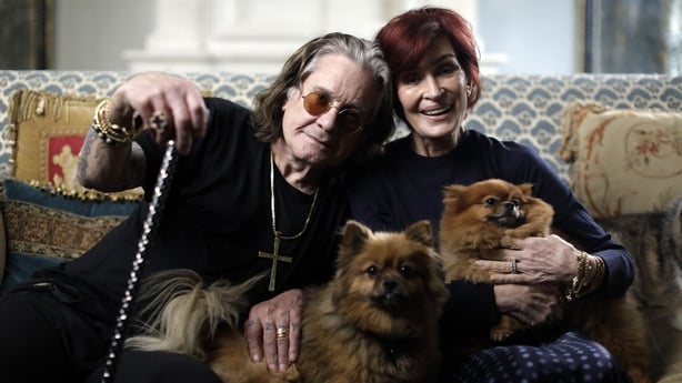 Ozzy Osbourne and Sharon Osbourne pose for a photo with their dogs